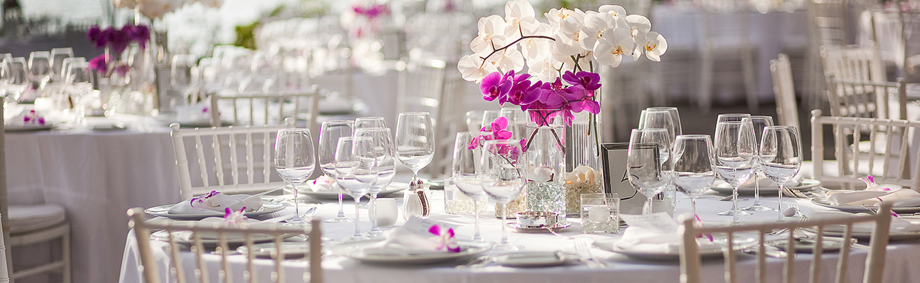 Events guests table decorated with flowers and cutlery